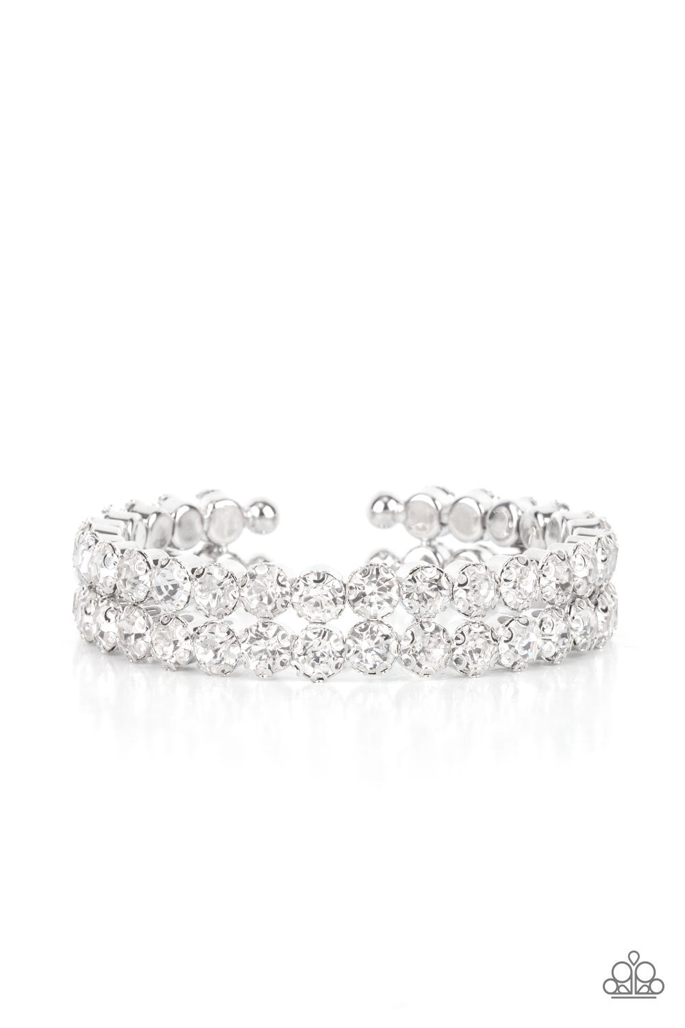 Encased in sleek silver fittings, two oversized rows of glassy white rhinestones stack into a blinding cuff around the wrist
