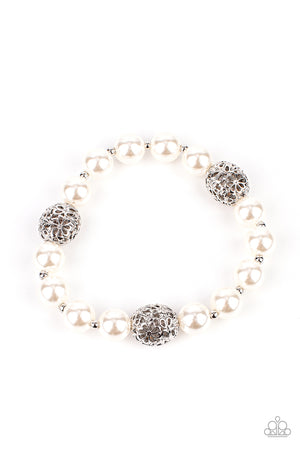 Airy silver beads, featuring a floral filigree design, add a touch of whimsy to a strand of luminous white pearl-like beads