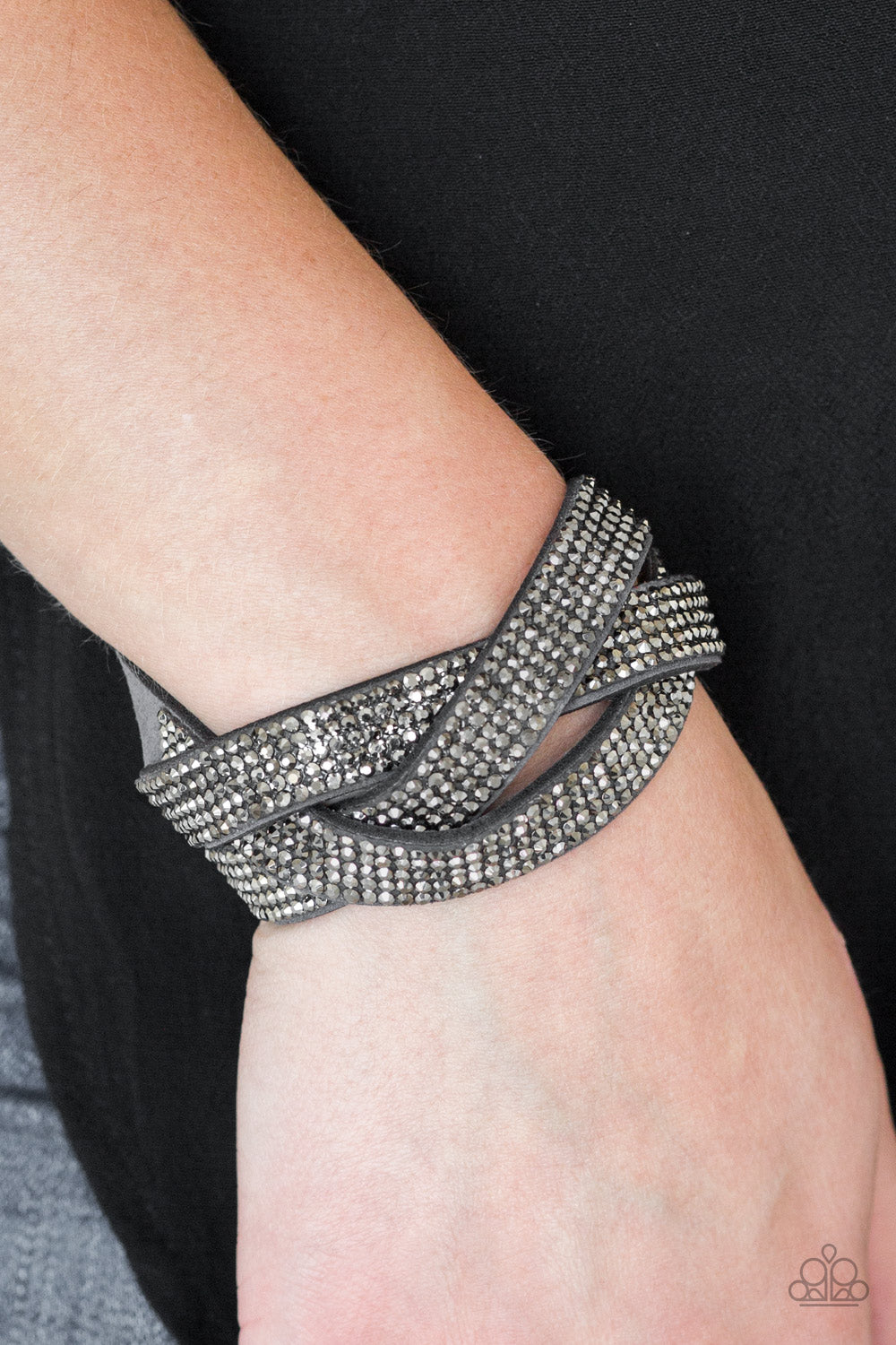 row after row of glittery hematite rhinestones, three gray suede bands