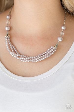 Oversized silver pearls and crystal-like beads give way to layers of beaded pearl strands