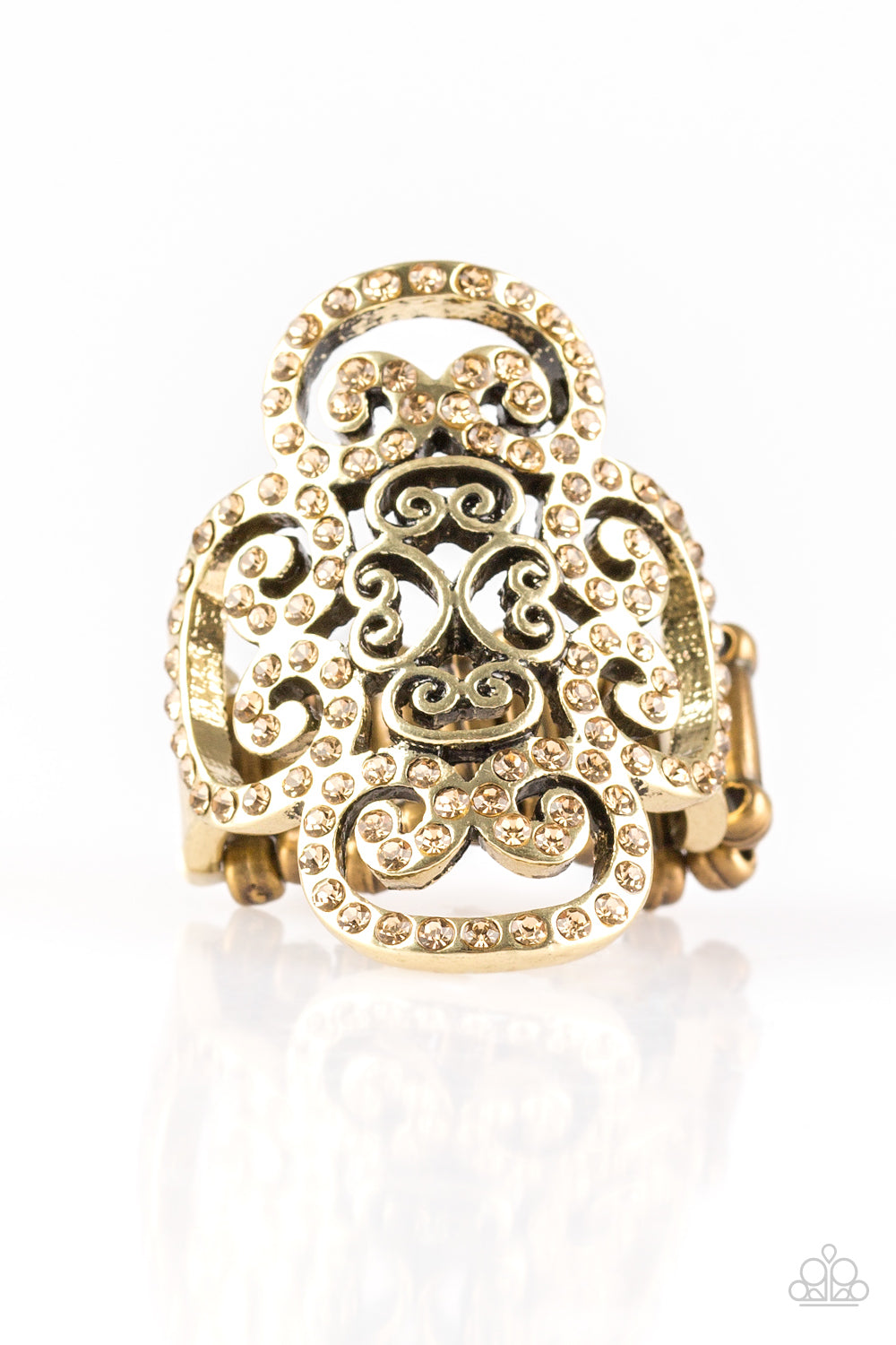 topaz rhinestones are encrusted along a glistening brass frame radiating with regal filigree
