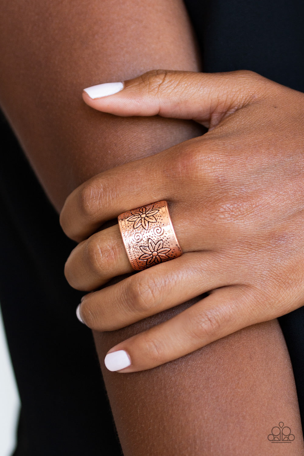 floral detail, a thick copper band 