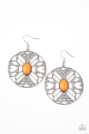 oval Amberglow bead adorns the center of a round silver frame radiating with an airy southwestern inspired pattern