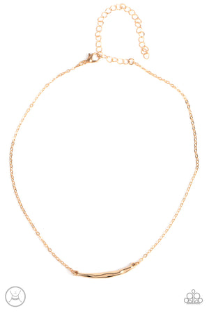 A hammered gold crescent attaches to a dainty gold chain around the neck for a trendy minimalist inspired look