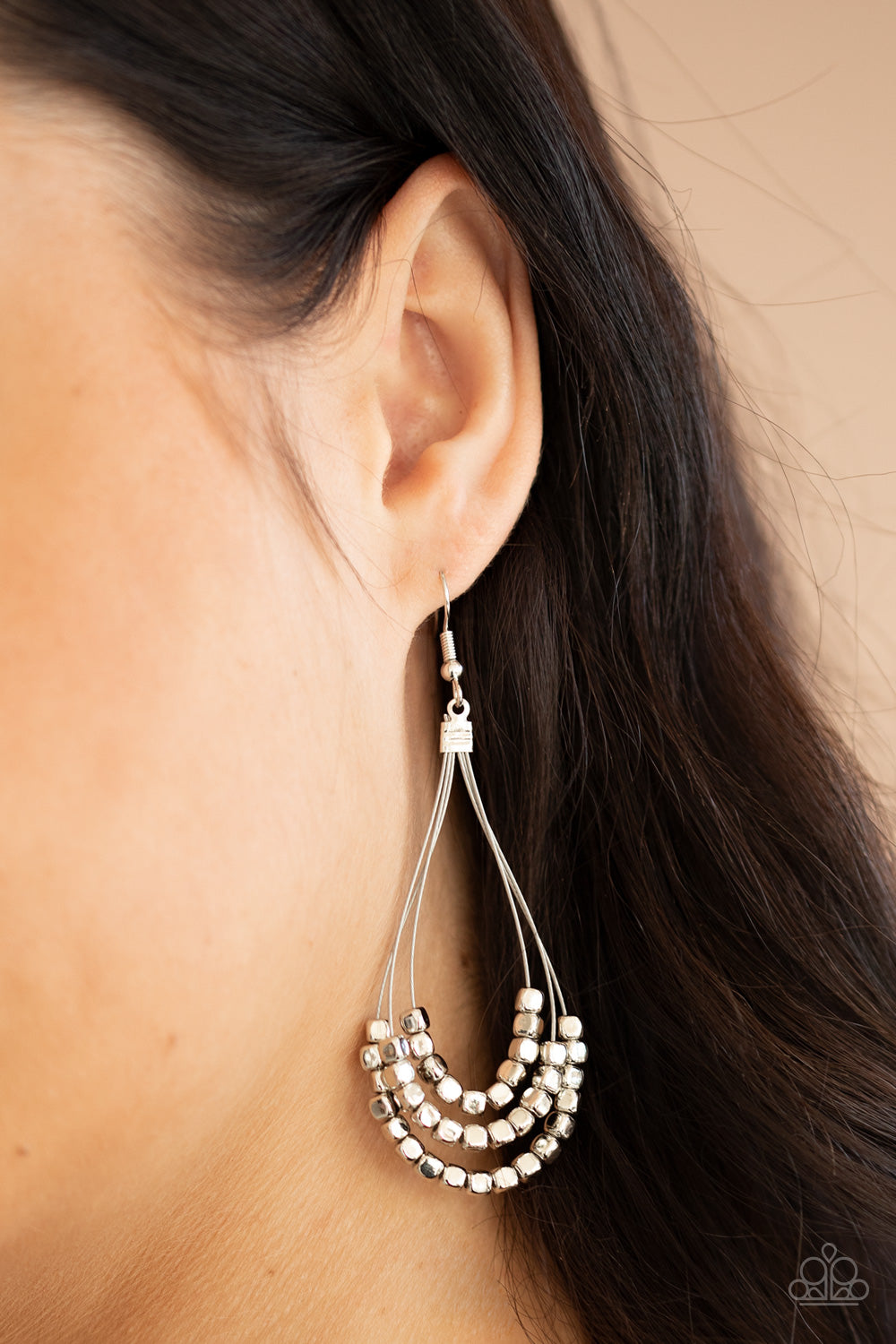 Three rows of dainty silver cube beads glides along shiny silver wire, layering into an edgy teardrop lure. Earring attaches to a standard fishhook fitting.