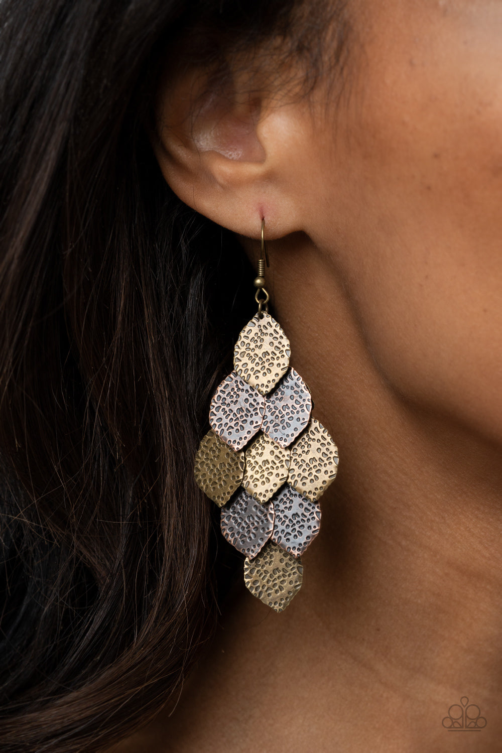 Hammered in antiqued details, leafy brass and copper frames cascade from the ear