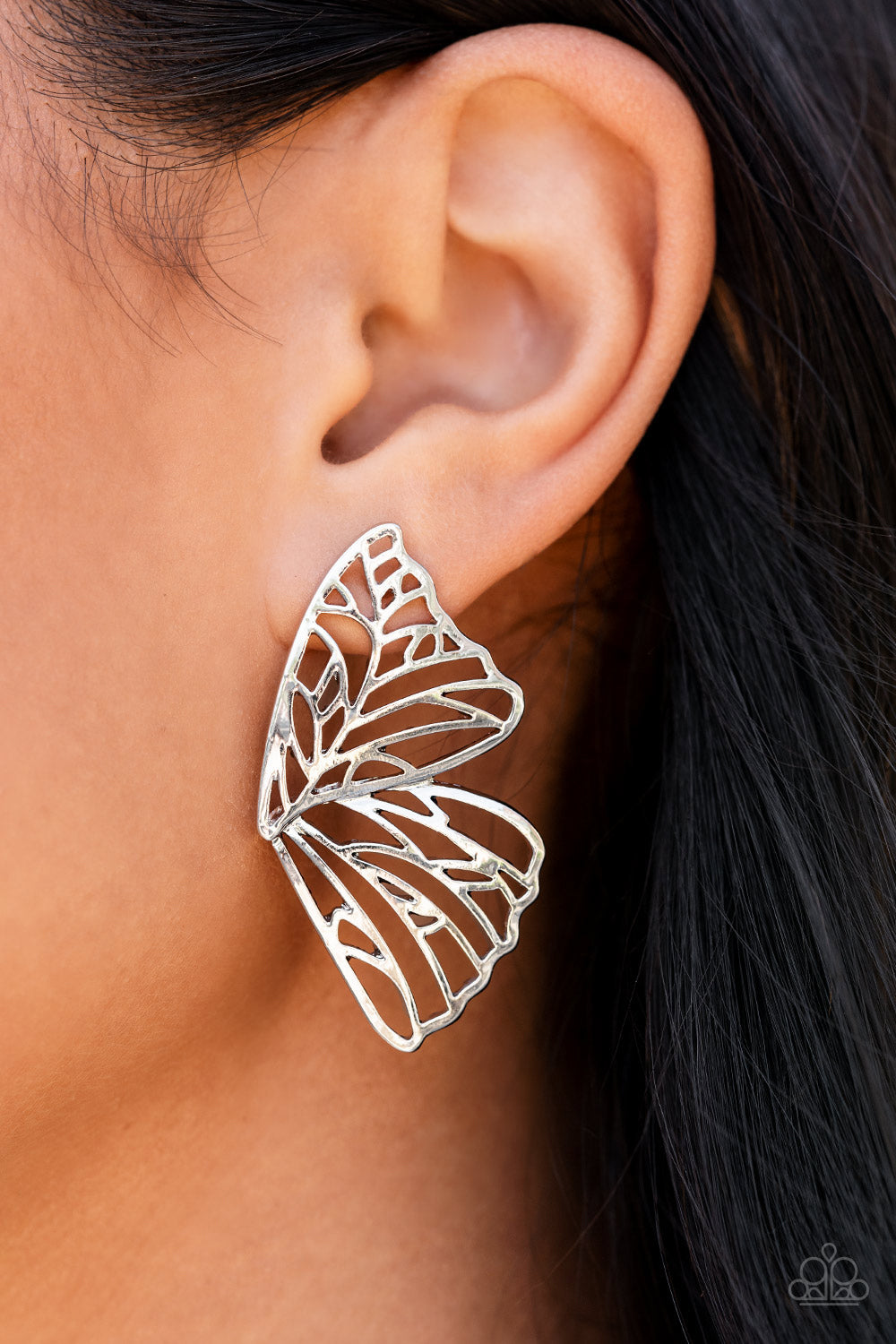 silver bars delicately climb scalloped silver frames, coalescing into a whimsical butterfly wing