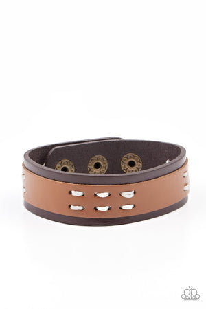 tan leather band is stitched in place across the front of a brown leather band