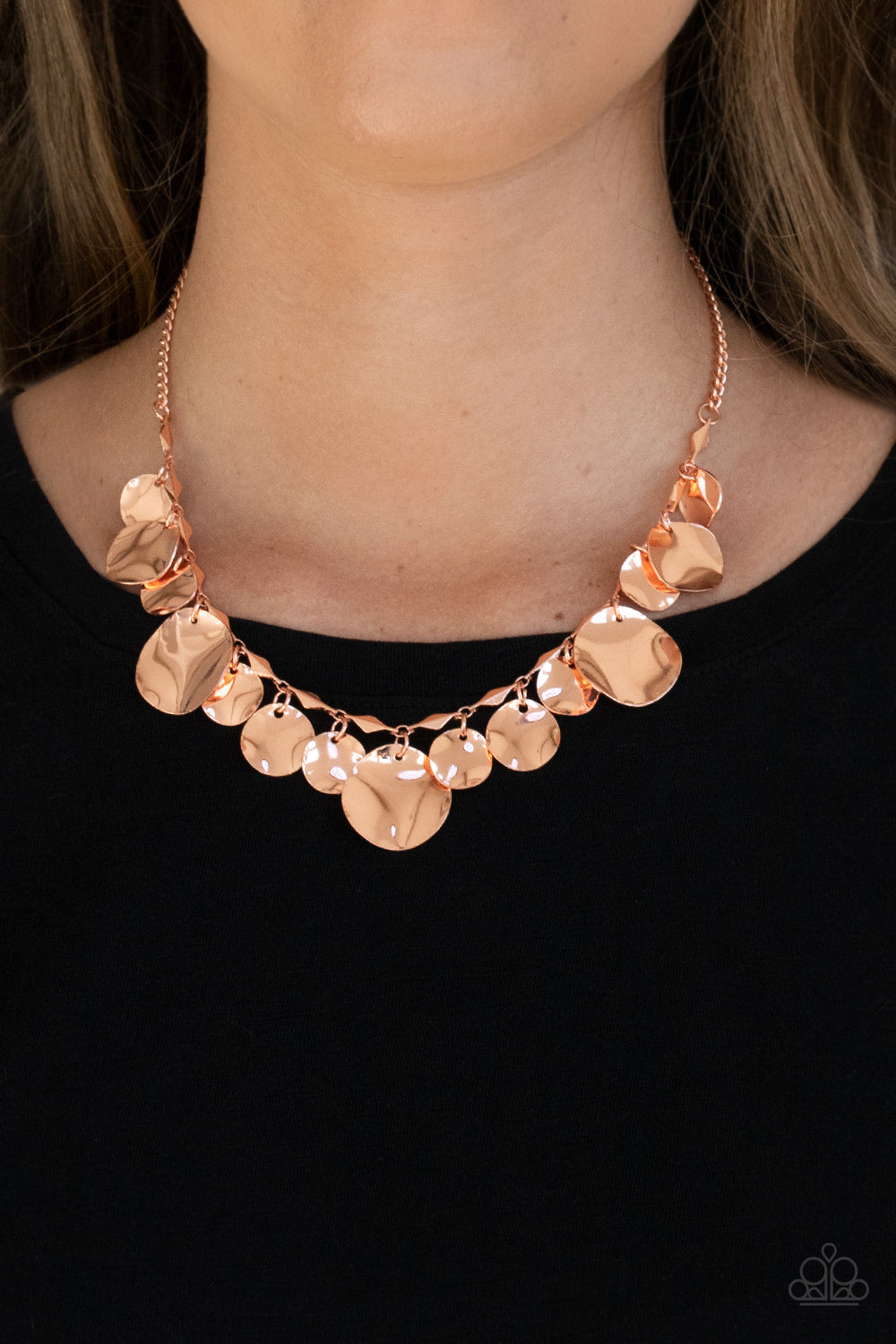 diamond shaped shiny copper fittings, a mismatched collection of hammered shiny copper discs