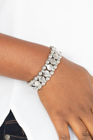 Shiny silver disc fittings and pairs of classic silver beads are threaded along stretchy bands
