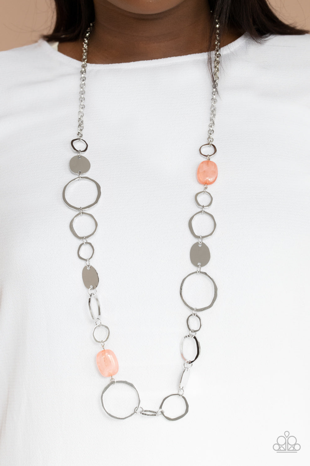 glassy coral accents, a shiny series of asymmetrical hoops and discs 