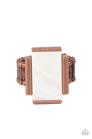 ridescent shimmer, a white shell-like rectangle is nestled between copper bar-like fittings