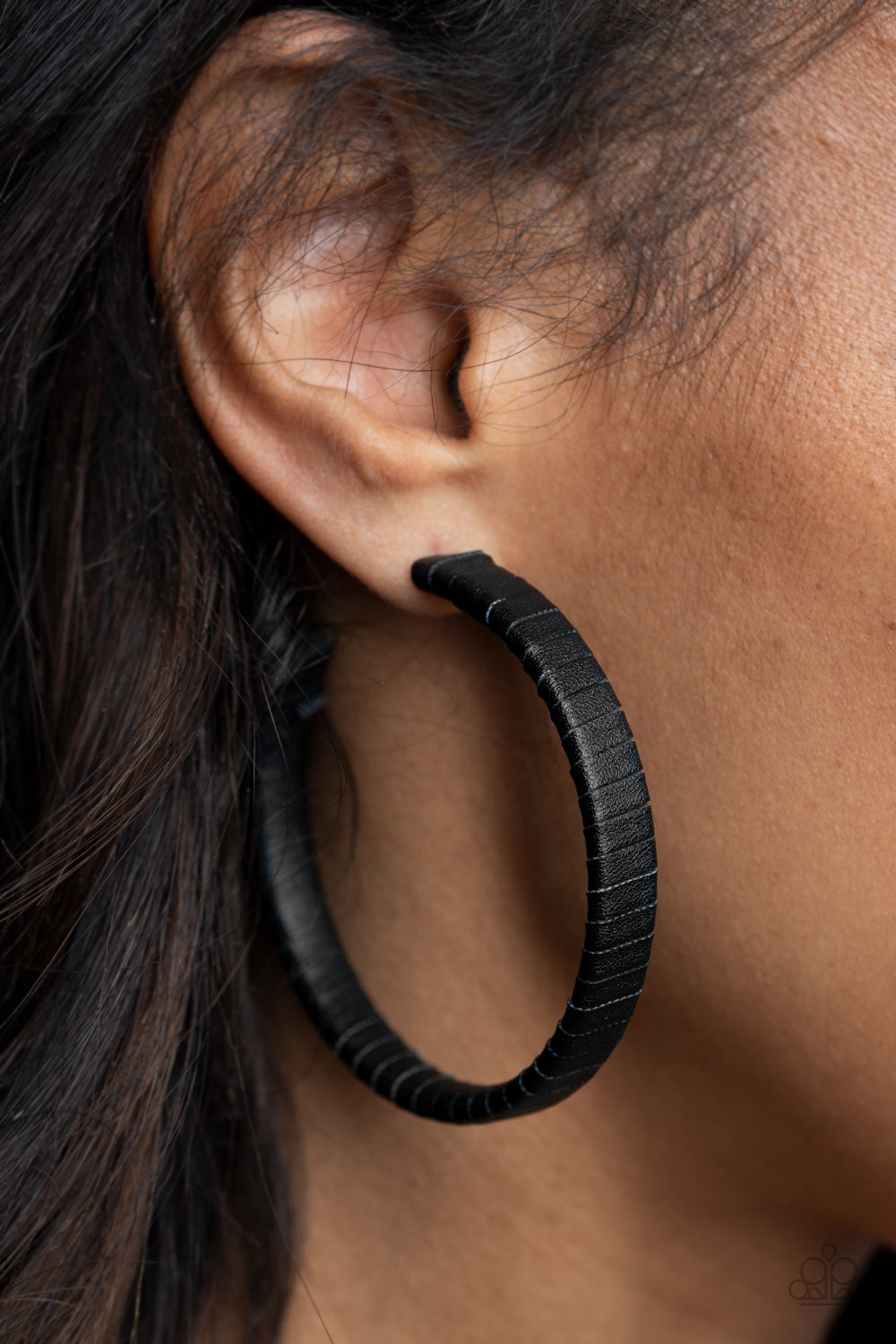 black leather lace wraps around a thick silver hoop