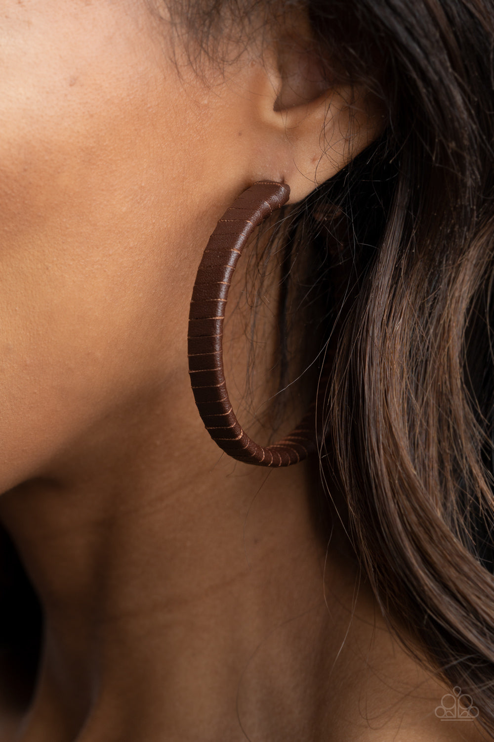 rustic brown leather lace wraps around a thick silver hoop