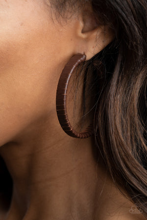 rustic brown leather lace wraps around a thick silver hoop
