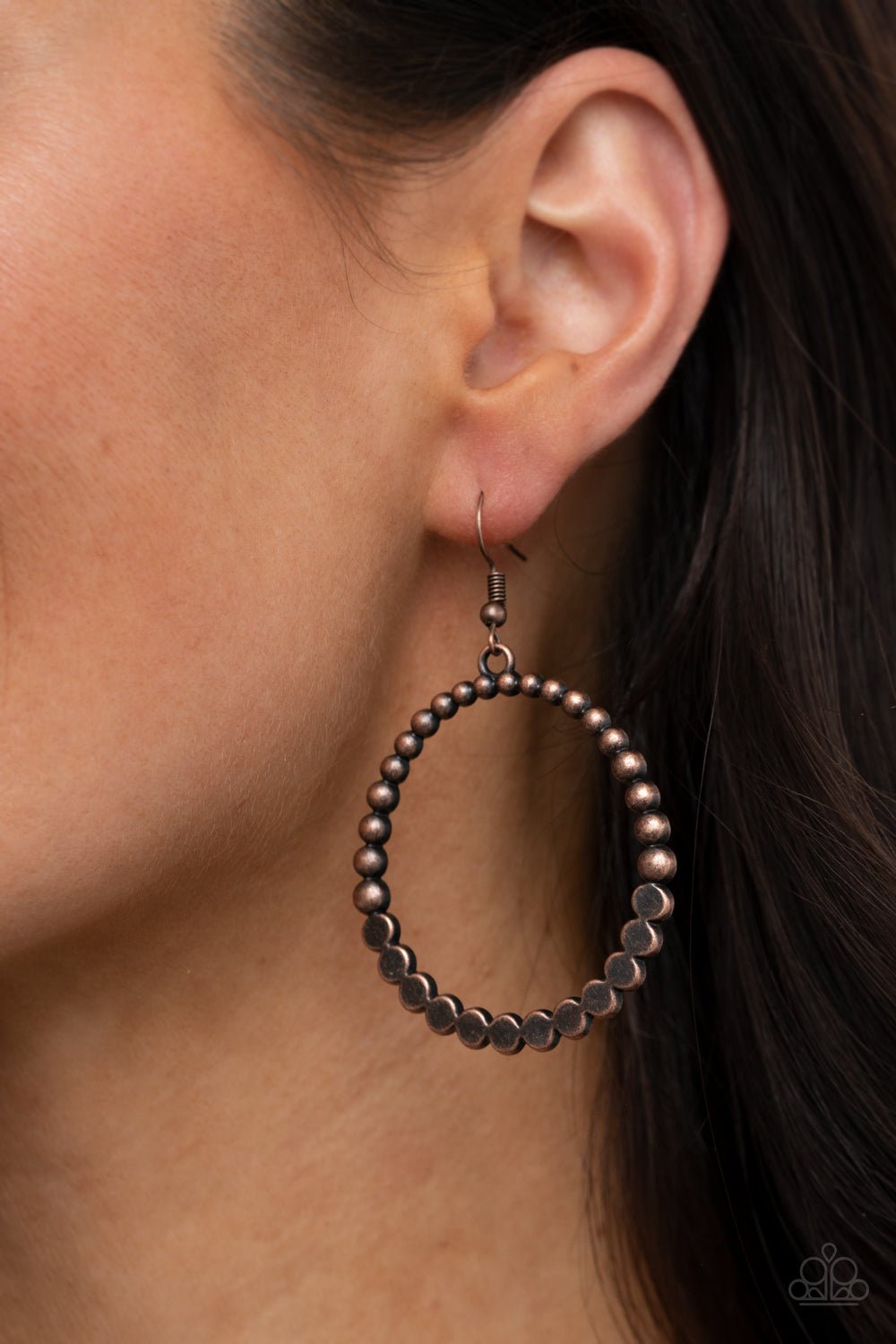 Antiqued copper studs join with flattened copper studs, creating a rustic hoop