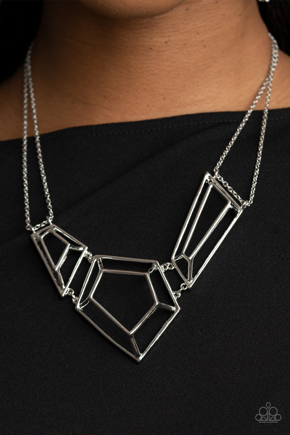 Glistening silver bars connect into edgy 3-dimensional frames 