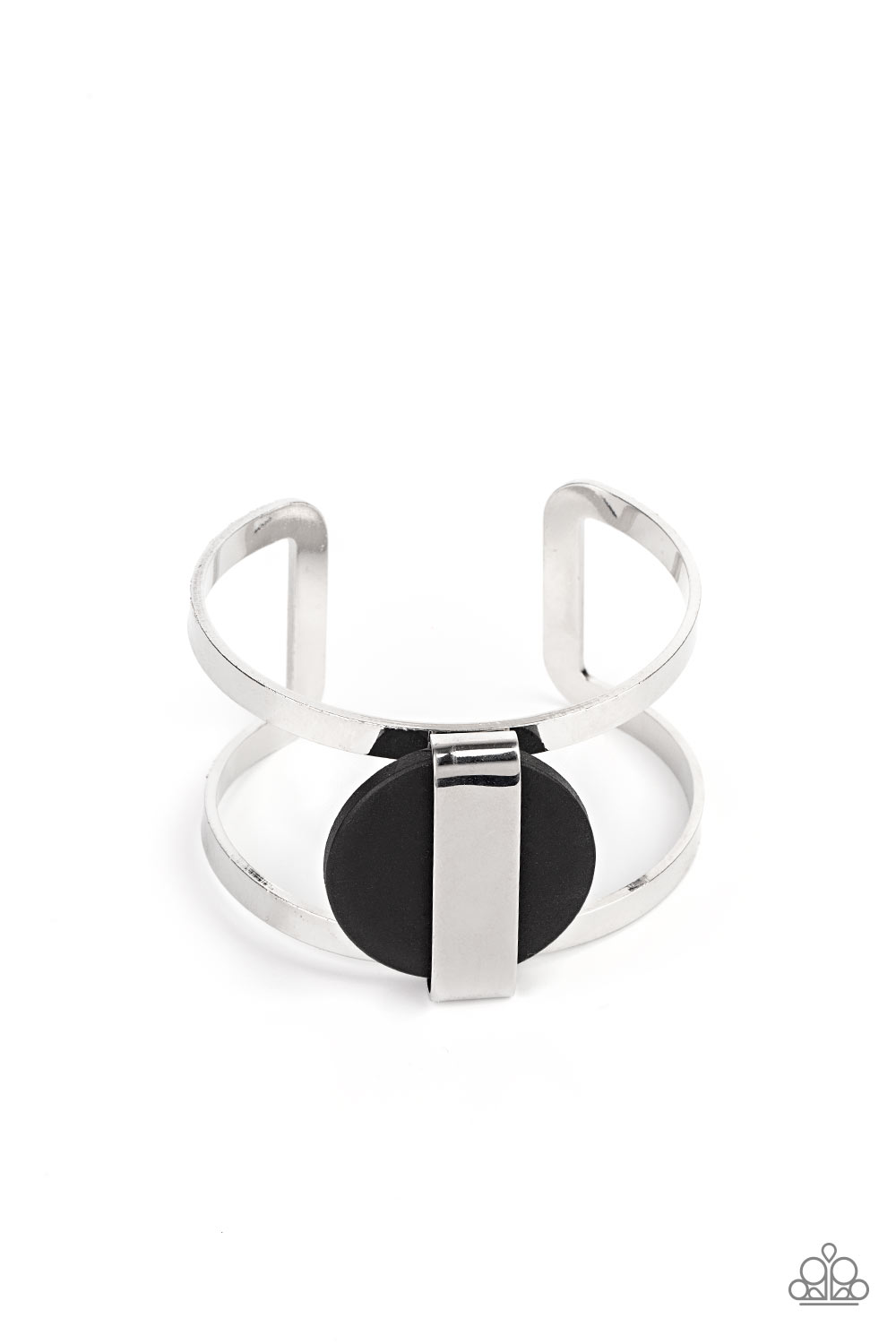 shiny silver frame wraps around an earthy black wooden disc, creating an abstract centerpiece atop a bold silver cuff