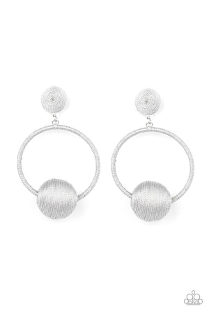 Shimmery silver thread wraps around an oversized bead that is fitted in place along the bottom of a matching threaded hoop
