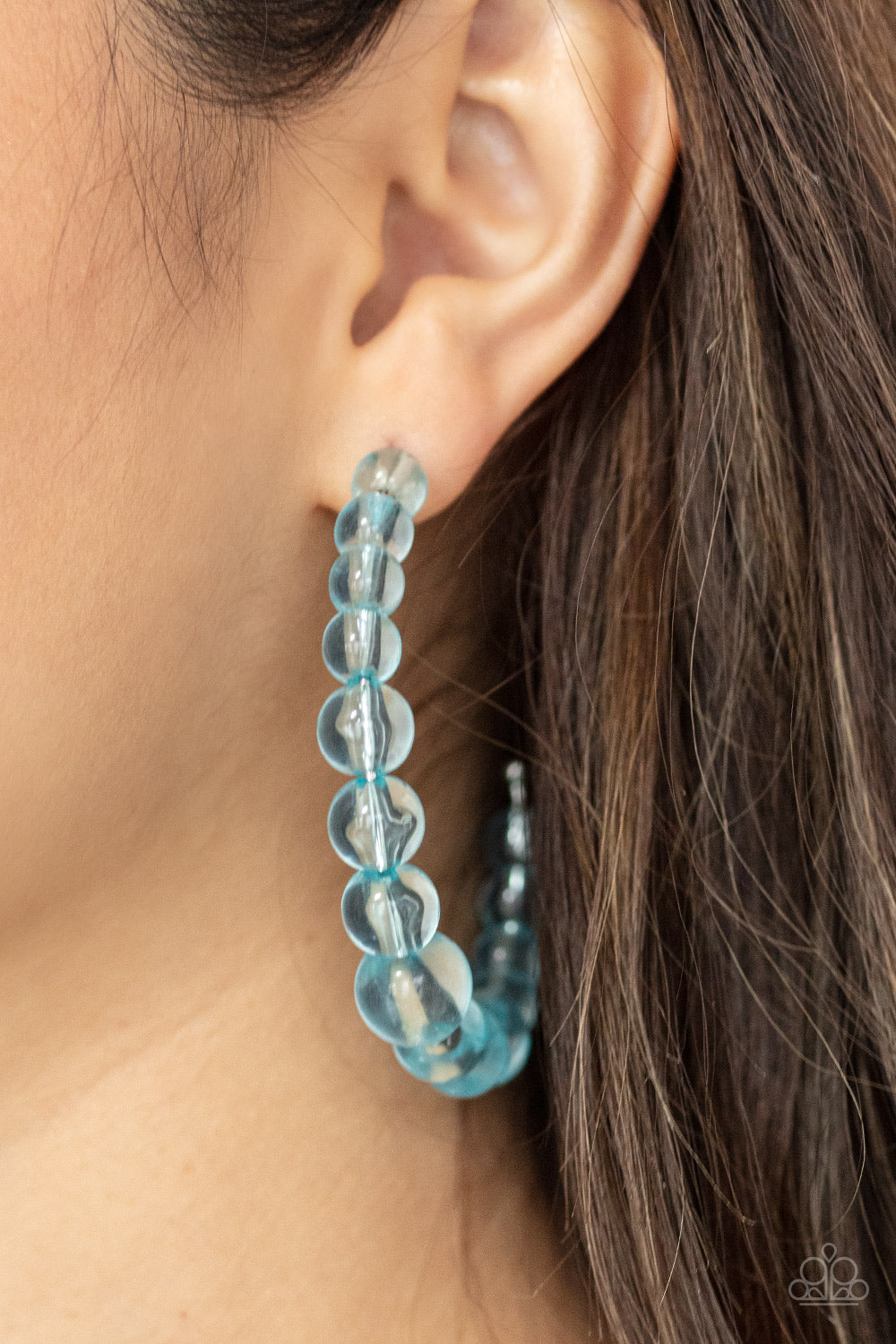  glassy collection of Cerulean beads are threaded along an oversized hoop for a bubbly effect