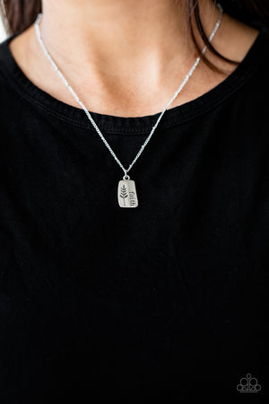 leafy accent, an asymmetrical silver plate is stamped in the word, "Faith"