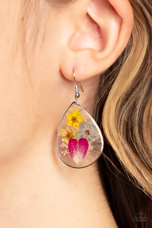 colorful collection of wildflowers is encased inside a glassy teardrop casing bordered in silver