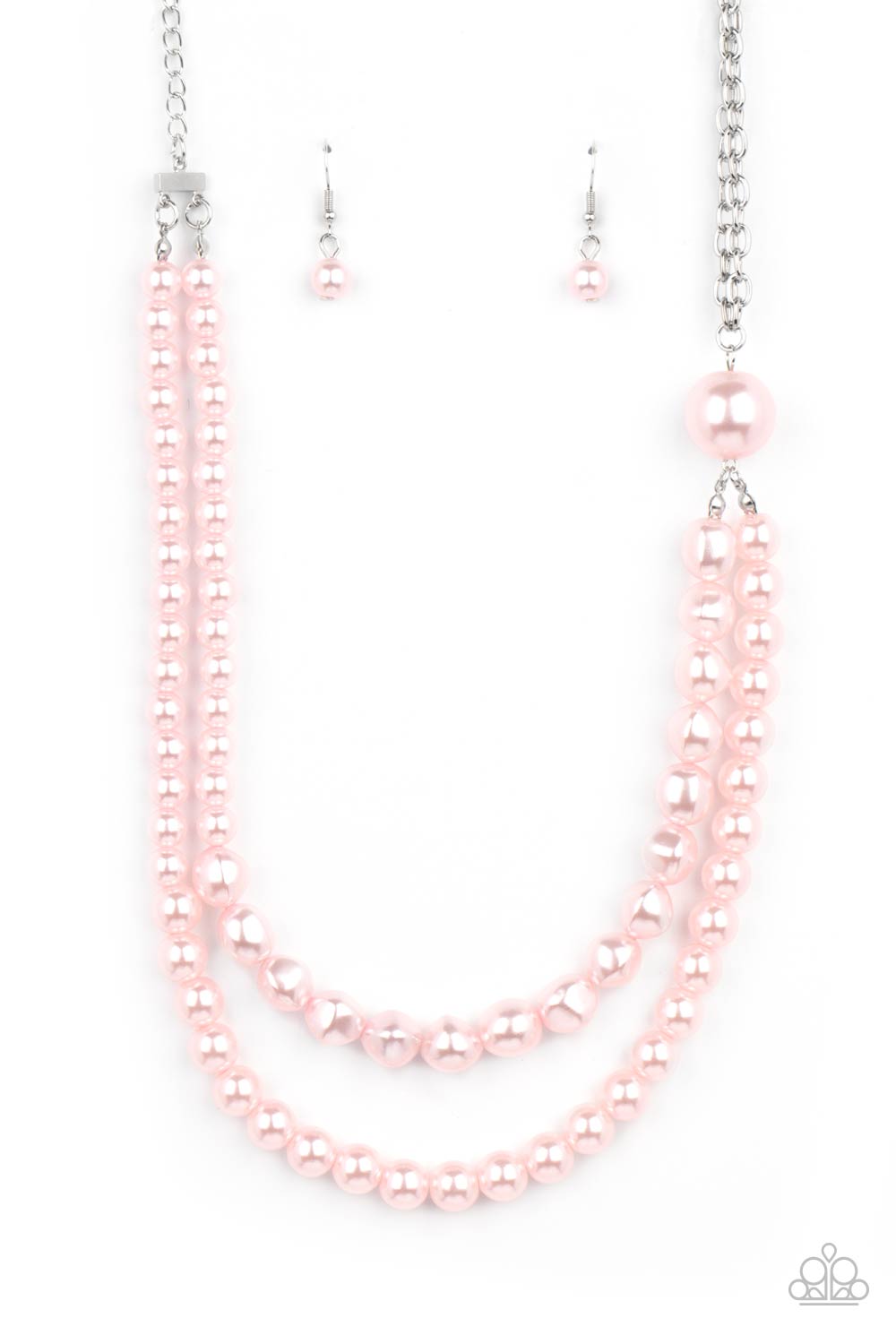 A dramatically oversized pink pearl gives way to two mismatched strands of classic pink pearls