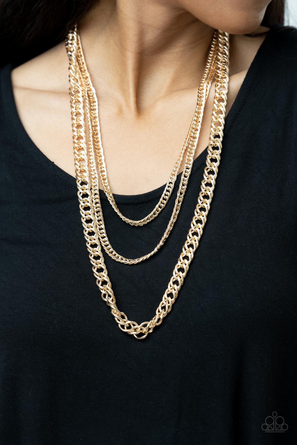 Bold layers of glistening gold chain of varying sizes and textures
