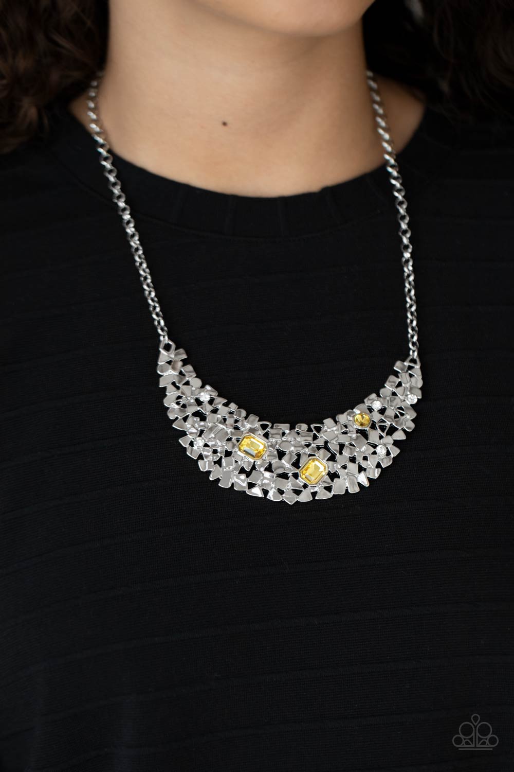 mismatched yellow and white rhinestones, a smattering of fragmented silver frames