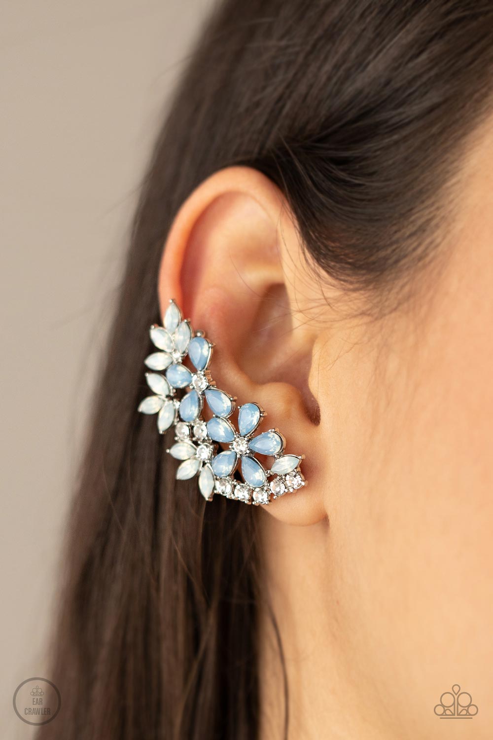  milky opalescence, white marquise and Cerulean teardrop rhinestones coalesce into a sparkly floral centerpiece that flawlessly climbs the ear