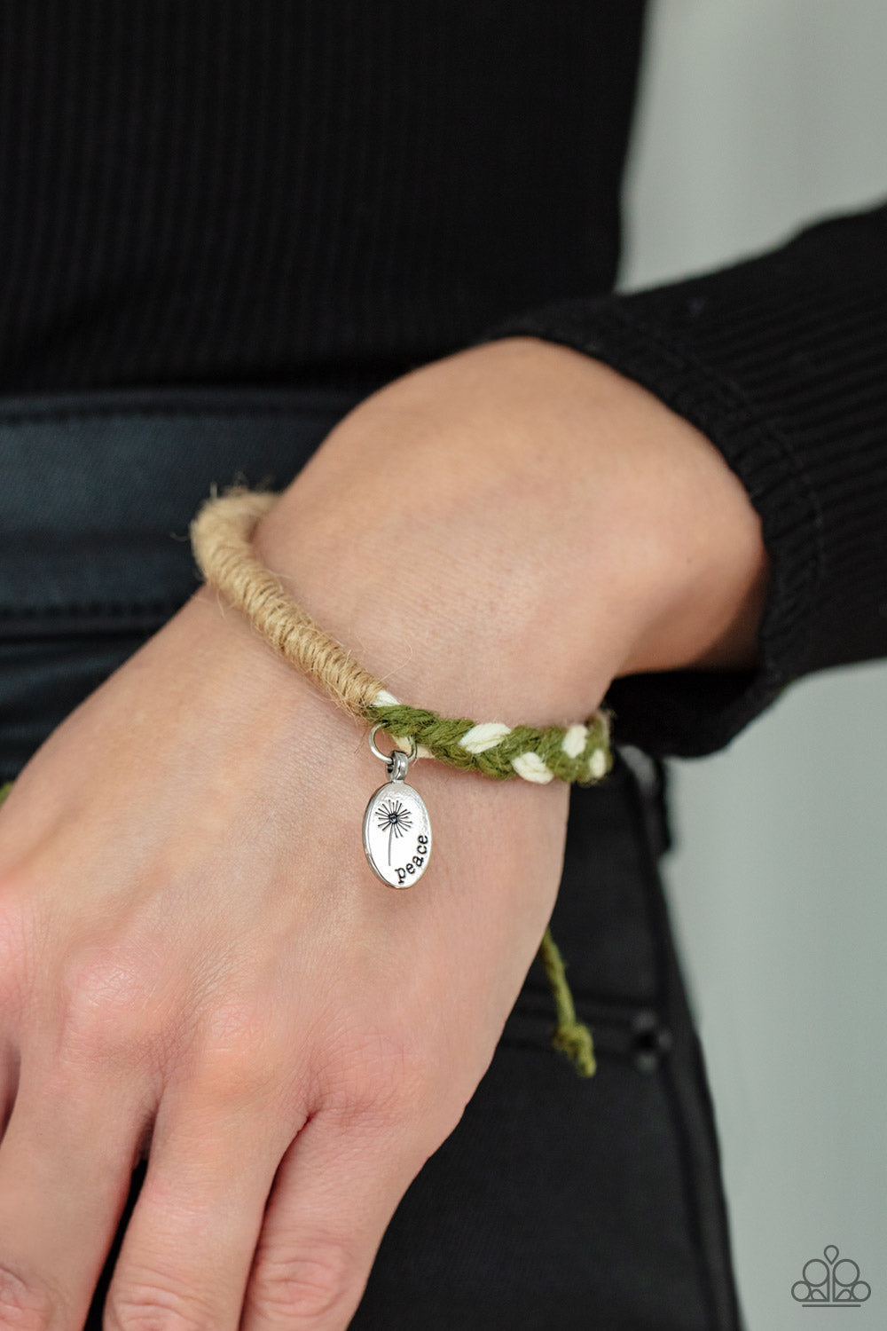 a blooming dandelion, a simple silver disc is stamped in the word, "Peace," creating a whimsical charm on a homespun bracelet