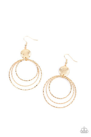 shimmery wavy gold disc links atop a collection of three delicately hammered gold rings in concentric sizes