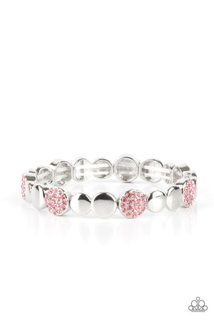 Glittery pink rhinestone encrusted frames and joined pairs of silver discs are threaded along stretchy bands around the wrist