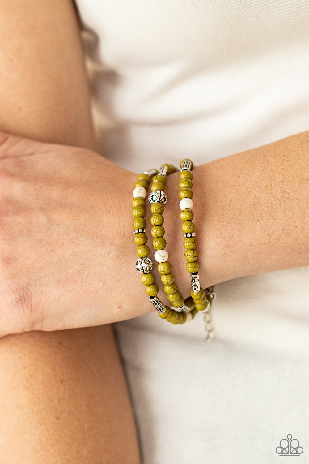 Willow and white stone beads, silver cube beads, and ornate silver accents are threaded along invisible bands around the wrist,