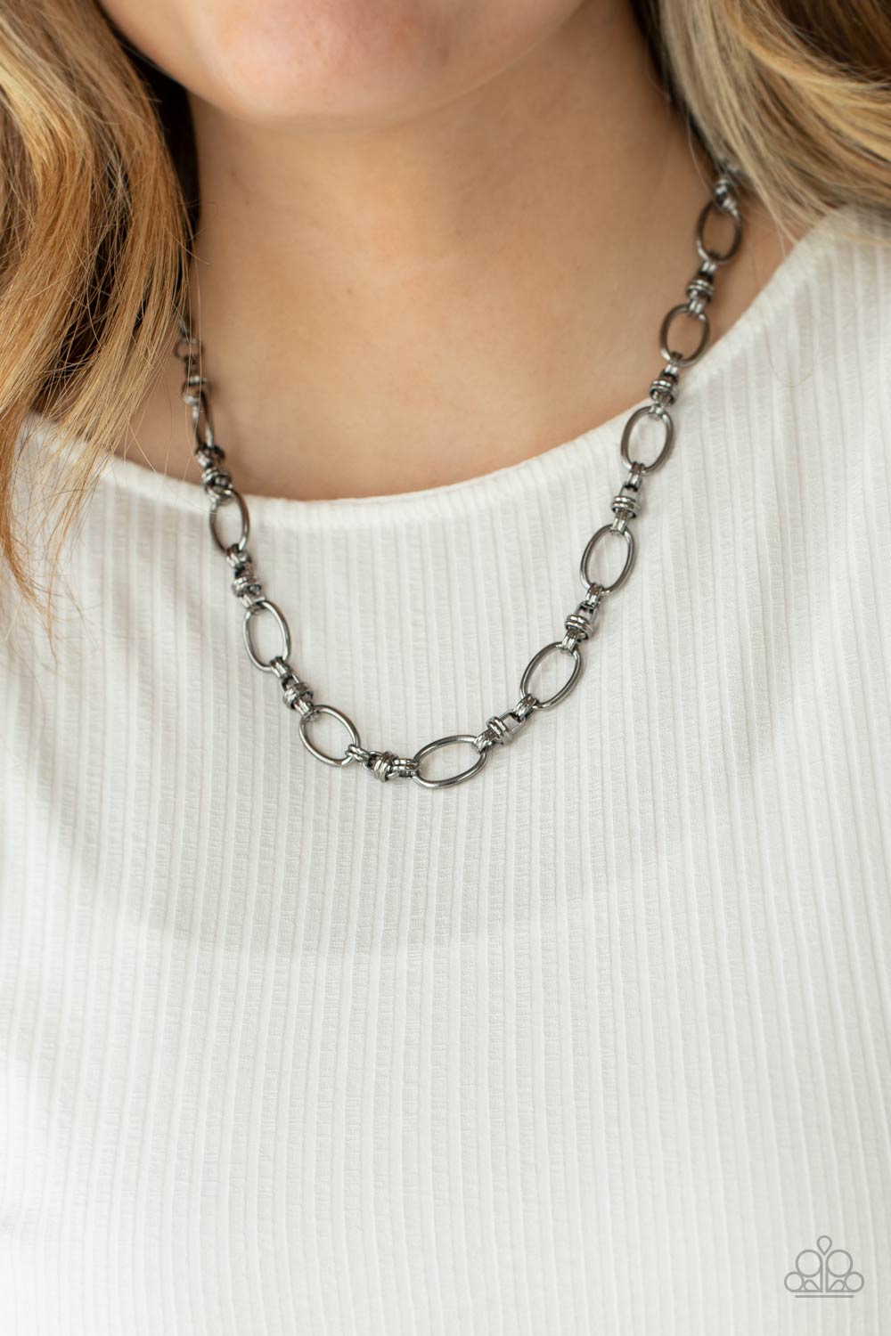 oined gunmetal links connect a collection of gunmetal oval frames below the collar, creating an edgy chain