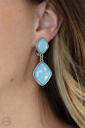 diamond shaped Cerulean opals are pressed into the centers of rustic silver frames