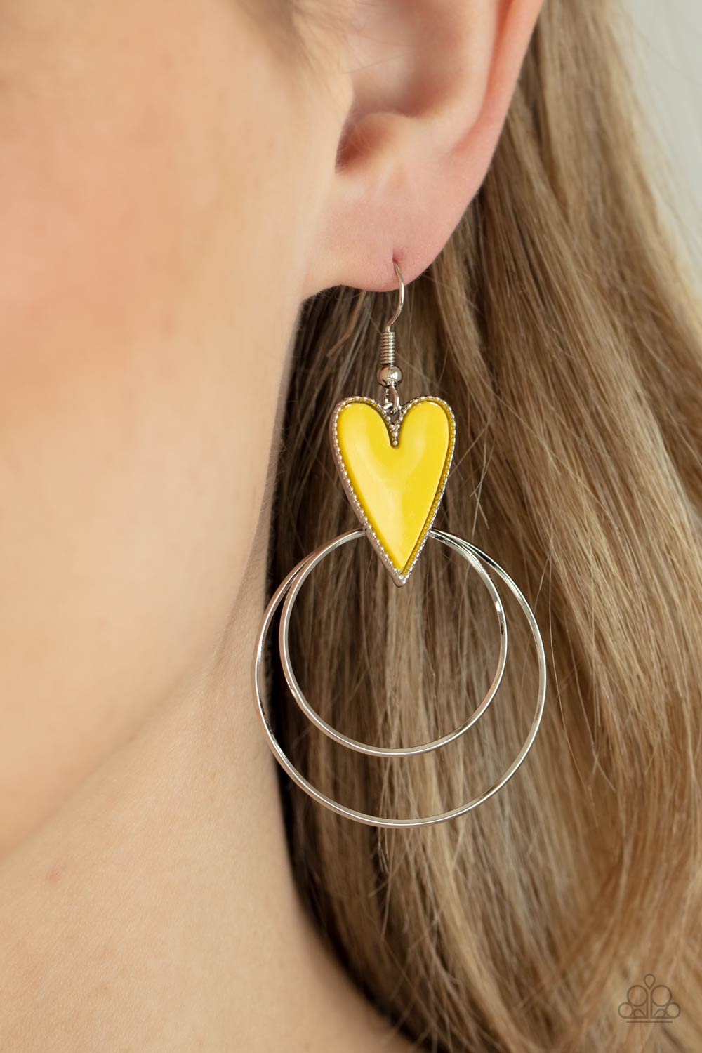 Dainty silver hoops attach to the bottom of a playful Illuminating heart frame