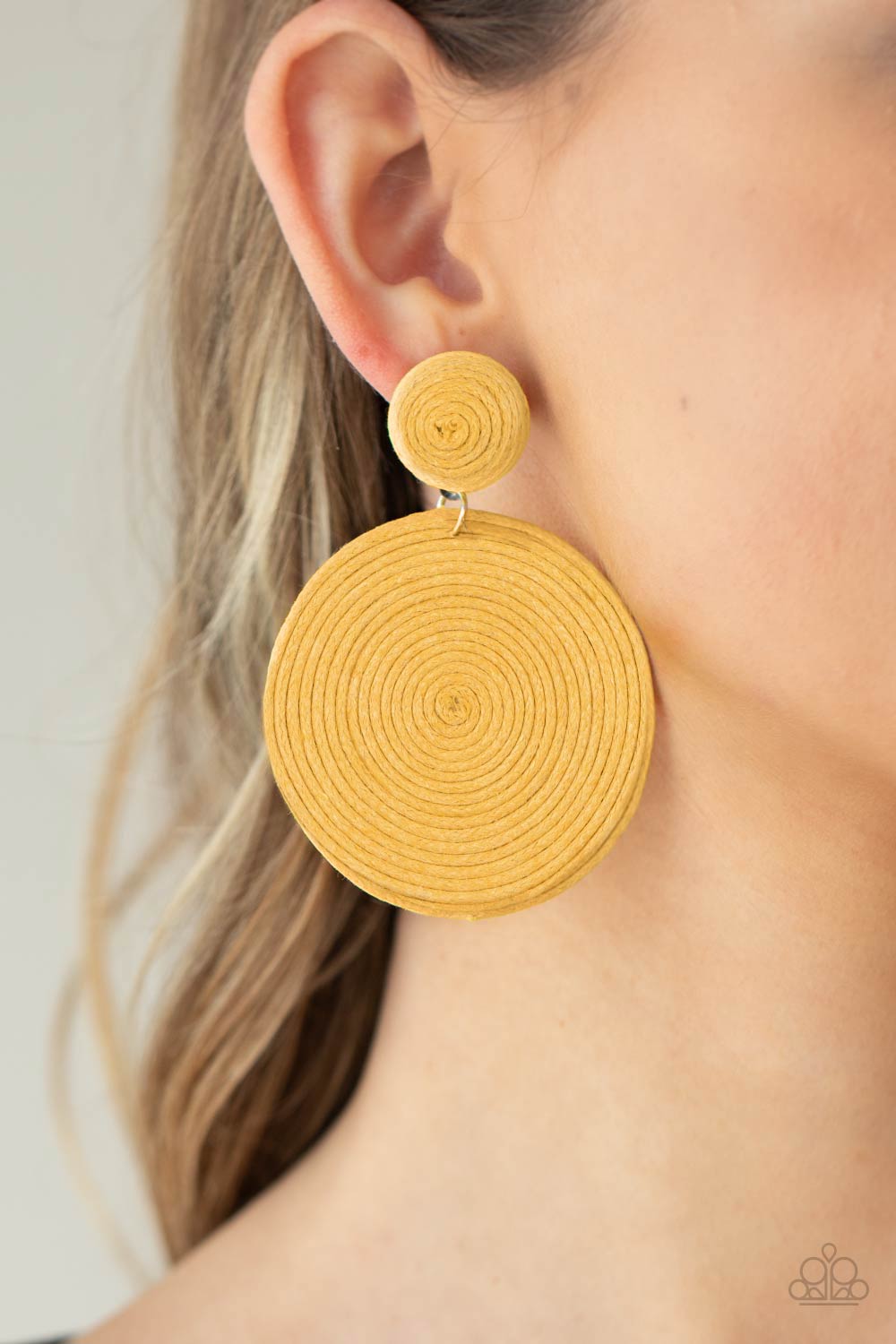 disc of yellow thread spirals around and around for a dizzying finish as it connects to a yellow threaded button post