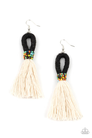 tassel of soft white cotton fans out under rows of brightly colored seed beads