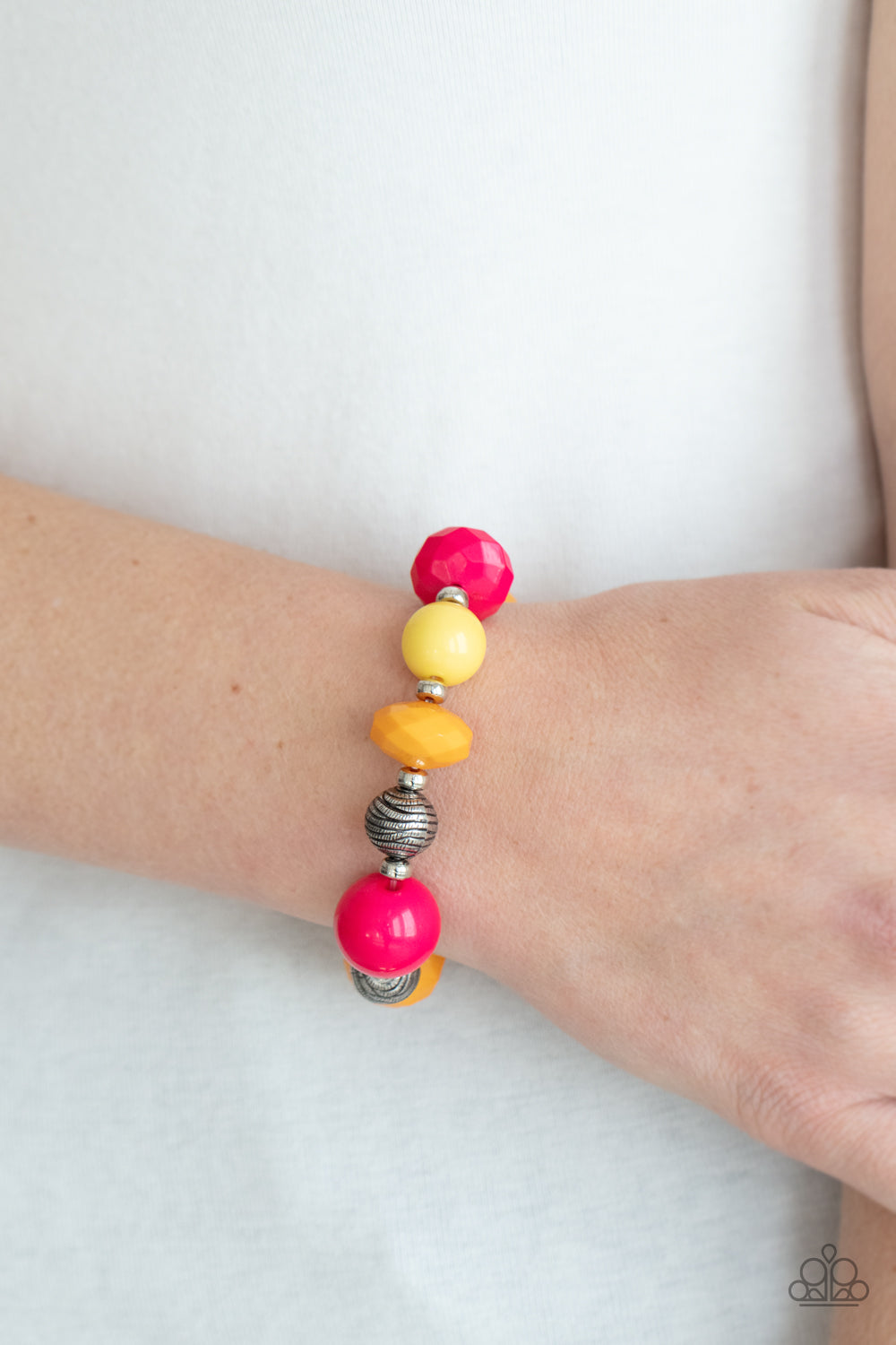 collection of brightly colored Raspberry Sorbet, Marigold, and Primrose beads in smooth round and faceted shapes, are threaded along a stretchy band