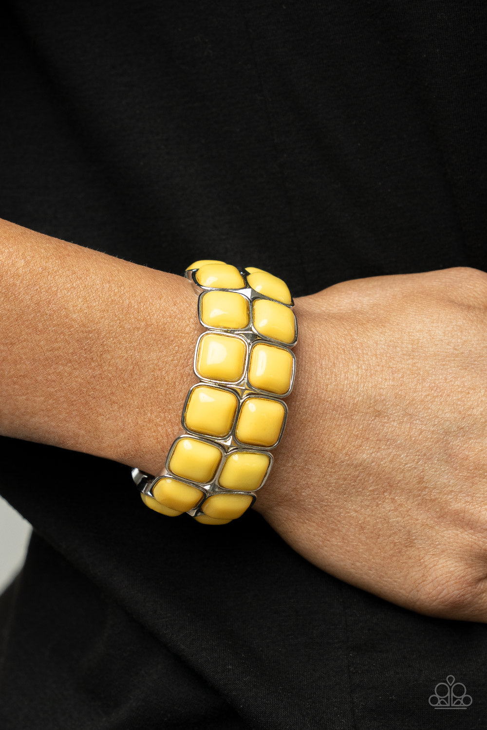 Stacks of cubed Illuminating beaded silver frames are threaded along a stretchy band