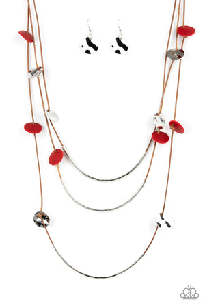 Shining wavy silver discs and red leather discs adorn a trio of lengthened subtly shimmering brown cords. Rows of dainty silver cylinders are threaded along the bottom of each cord adding luxurious allure to the piece.