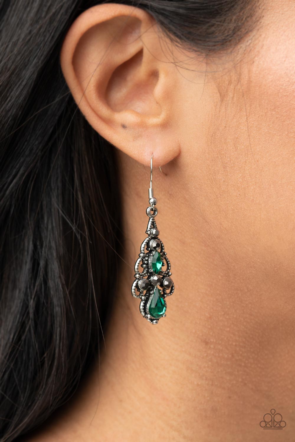Embellished in mismatched green and hematite rhinestones, studded silver filigree swirls into an airy chandelier, creating a regal lure