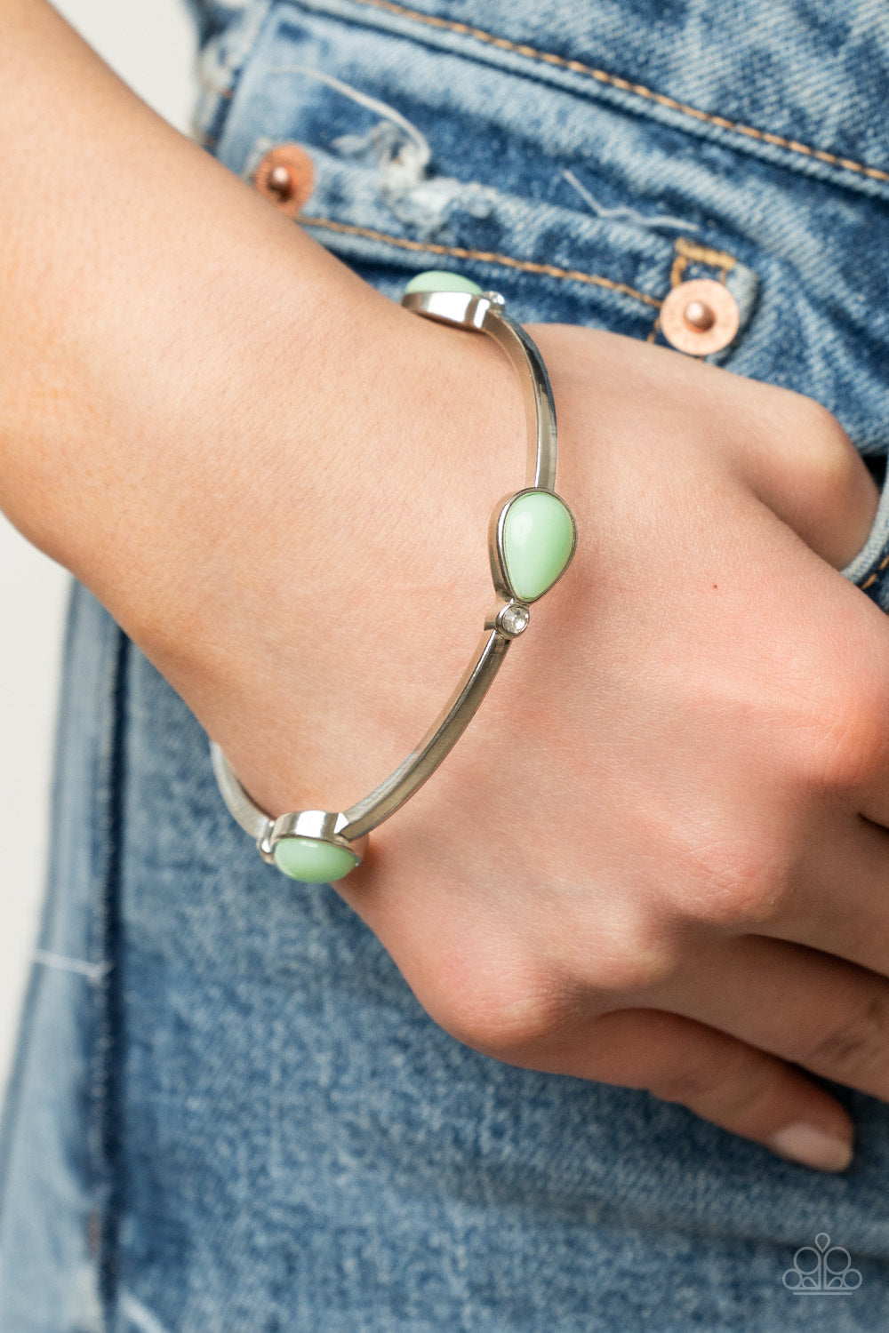 glassy Green Ash teardrops and dainty white rhinestones embellish a classic silver bangle