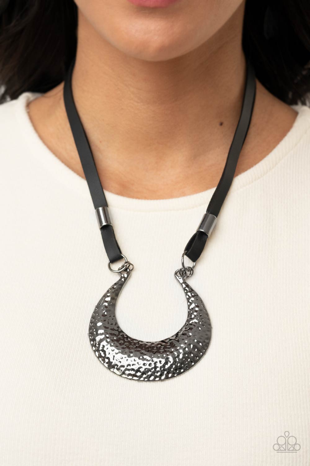 gunmetal beads, strips of black leather link to an oversized half moon pendant that is hammered in a blinding gunmetal finish