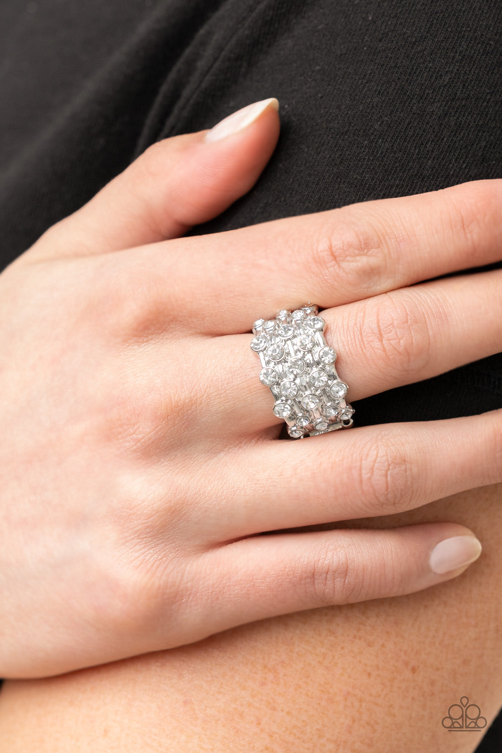 Sparkling white rhinestones encased in silver frames line up in layers across shiny silver bands