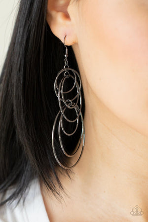 Varying in size, a shiny collection of mismatched gunmetal hoops haphazardly connect into a dizzying lure.