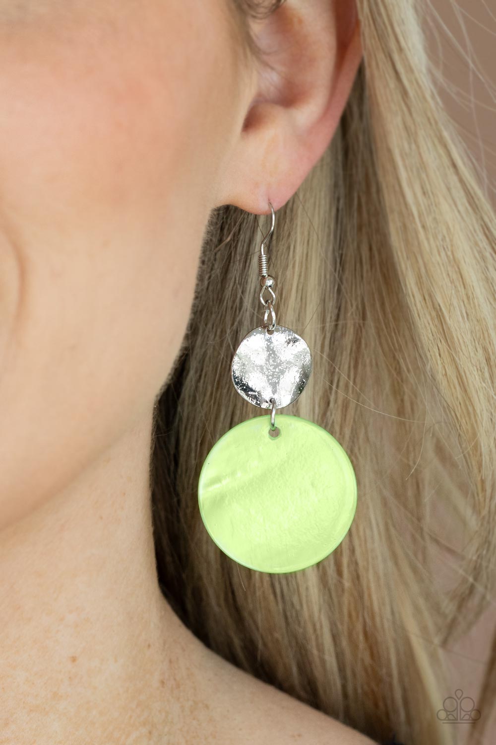 oversized green shell-like disc is topped by a wavy, sparkling silver disc