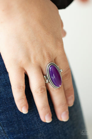 glassy iridescence, an oval purple acrylic bead is pressed into the center of textured silver fittings, creating a mystical centerpiece atop the finger