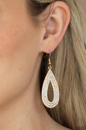 Three glittery rows of glassy white rhinestones coalesce into a sparkly golden teardrop